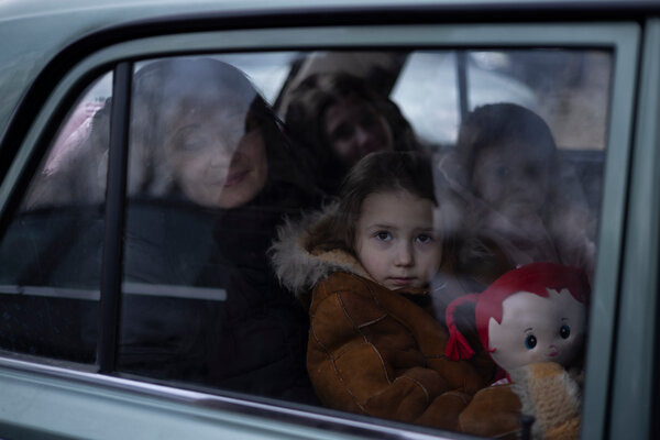 Maria Pikush and her three daughters waiting to be picked up in Przemysl, Poland, after fleeing Ukraine.