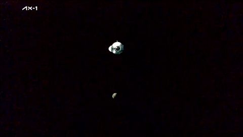 De SpaceX Ax-1 Dragon-capsule nadert het internationale ruimtestation, de maan op de achtergrond.