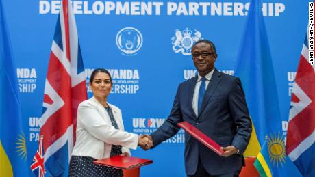 De Britse minister van Binnenlandse Zaken Priti Patel schudt de Rwandese minister van Buitenlandse Zaken Vincent Beirutari de hand na de ondertekening van de partnerschapsovereenkomst op een gezamenlijke persconferentie in Kigali, Rwanda, op 14 april.